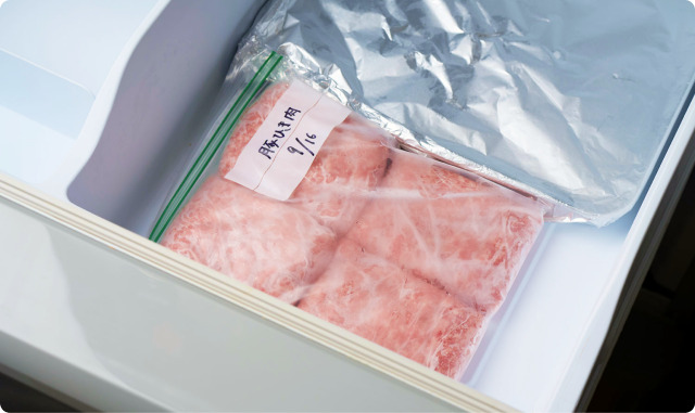 バットにのせた冷凍保存袋入りのひき肉を冷凍庫に入れたところ